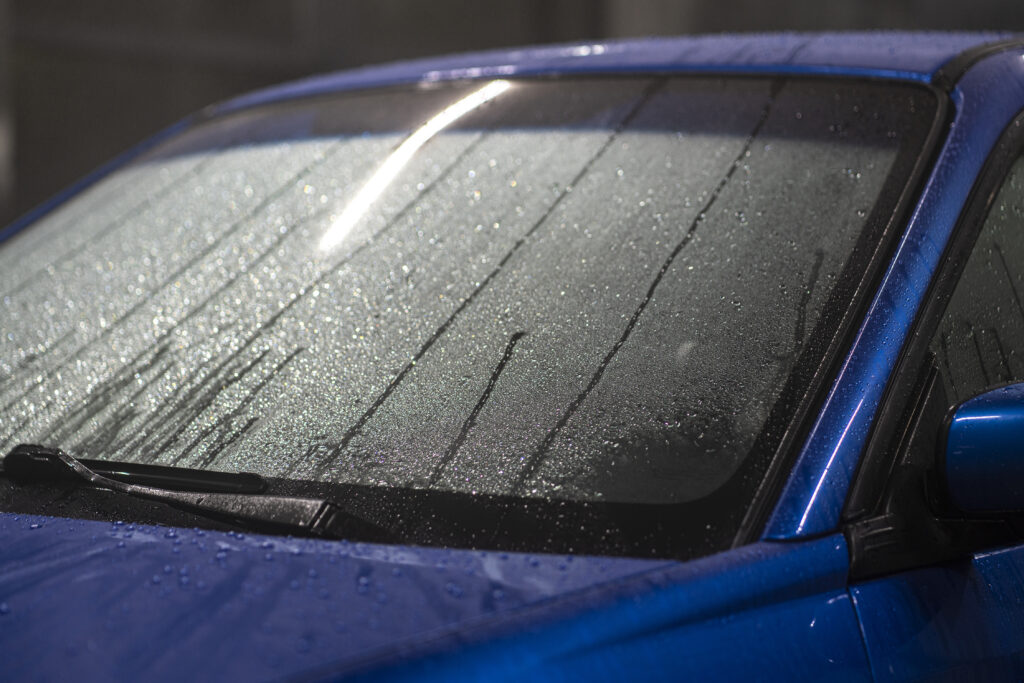 a car shiny hydrophobic coating, close up waterdrops on the automobile