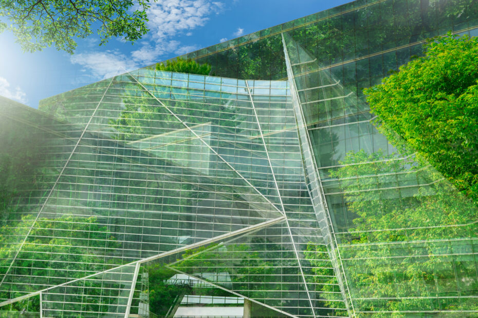 Sustainble green building. Eco-friendly building. Sustainable glass office building with tree
